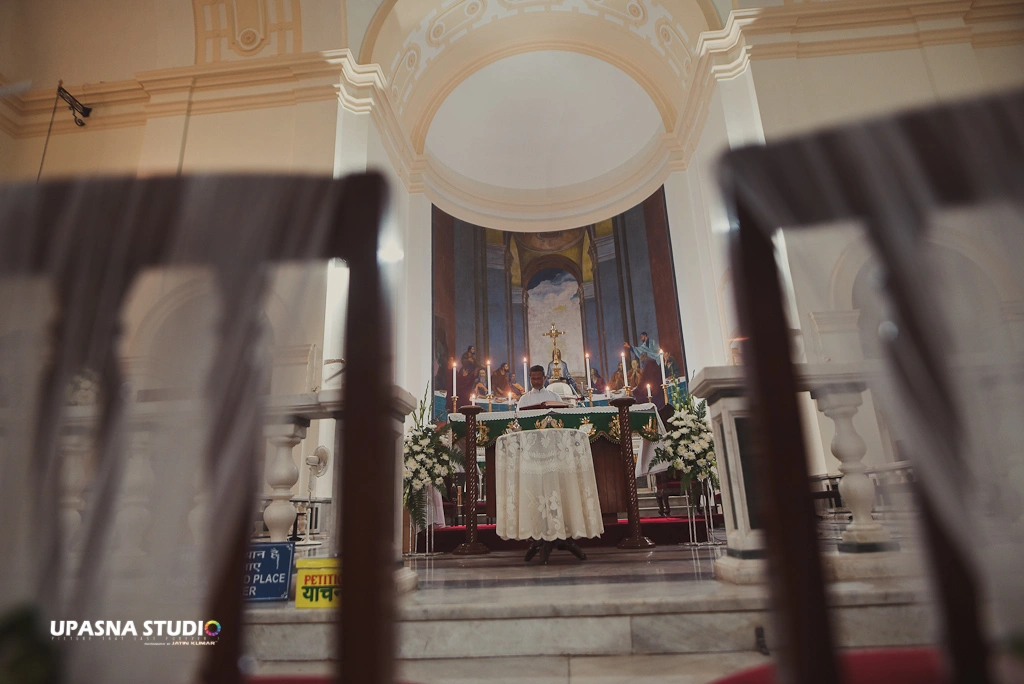 A wedding ceremony in a church with rows of chairs neatly arranged for guests to witness the special occasion.