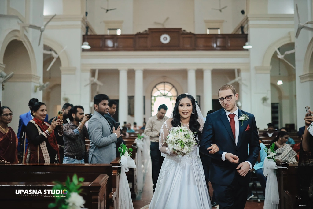 Wedding Photographers in Delhi | Upasna Studio | Couple entering a church.